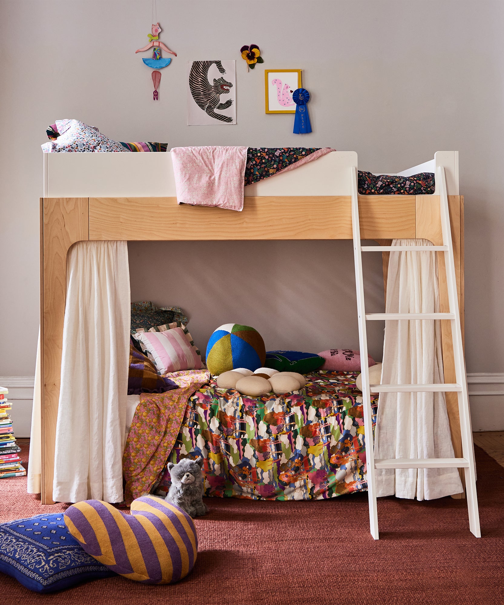 The Perch Full Bunk Bed features a ladder and creates a cozy room for kids, perfect with colorful bedding, pillows, toys, and fun wall decor.
