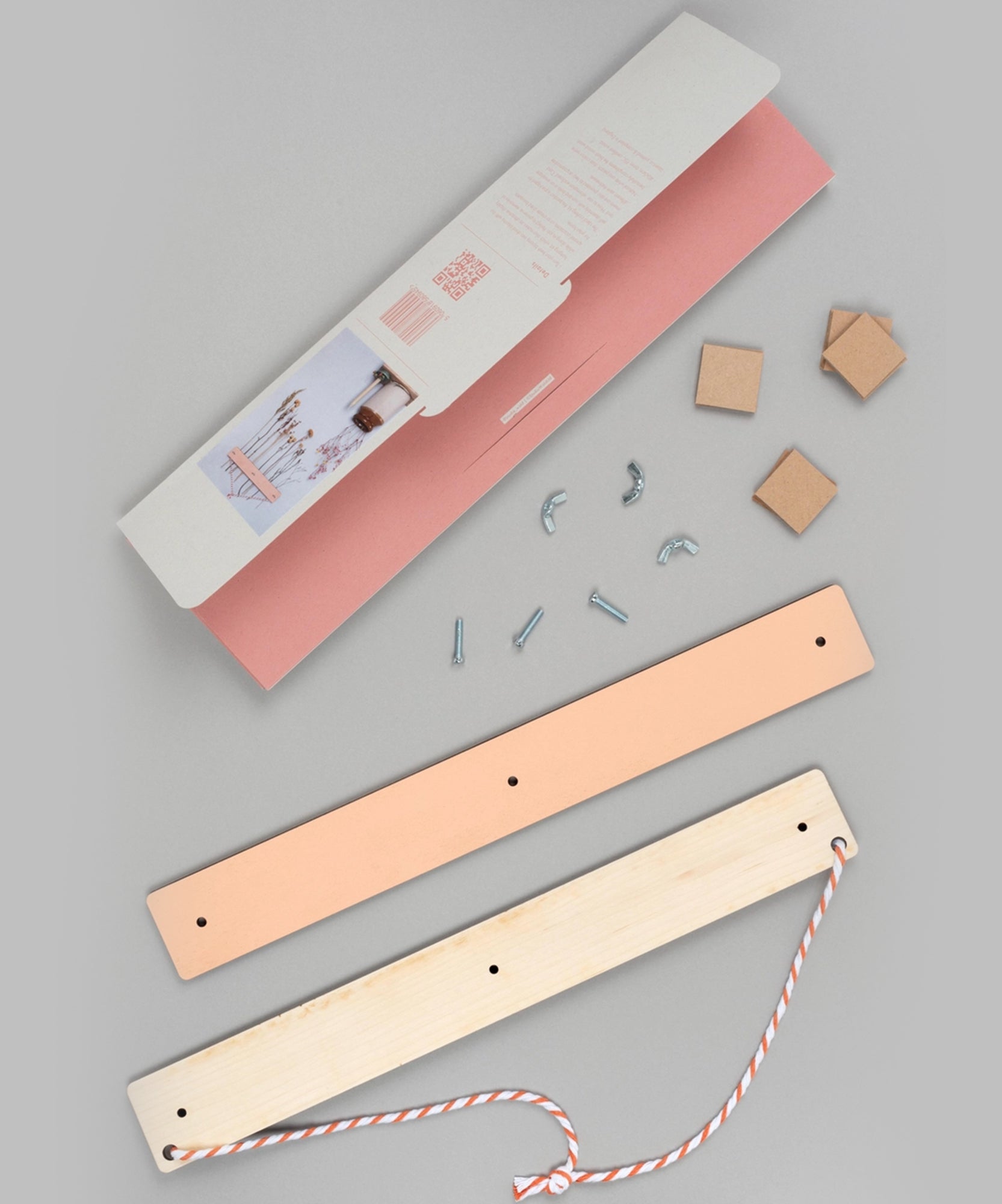 Flower Drying Kit with two wooden boards, screws, hooks, rope, and small cardboard squares on a grey surface.