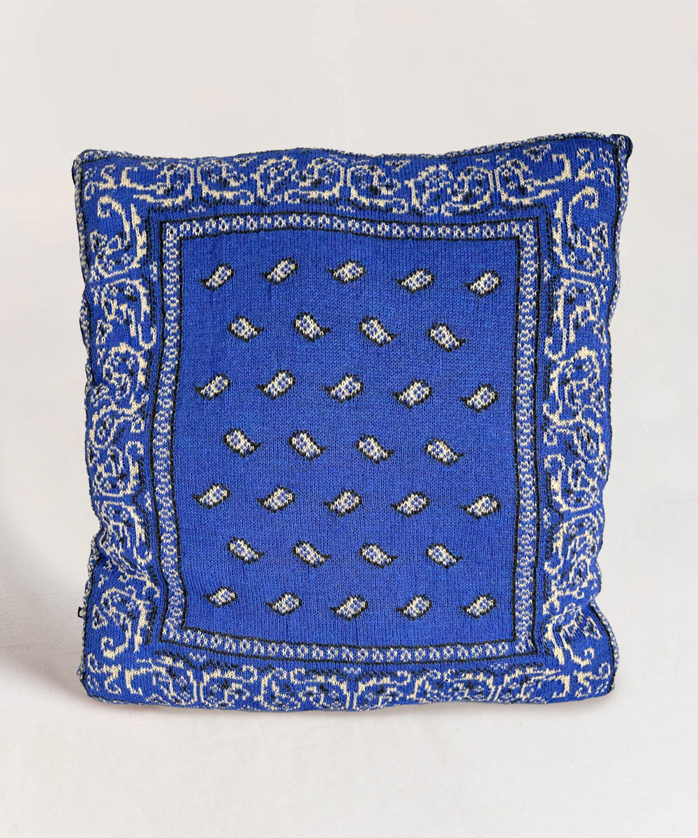 Bandana Pillow: A blue pillow featuring intricate white patterns and a central grid of small white motifs.